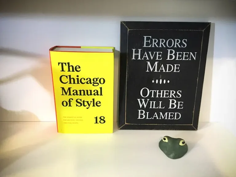 New edition of The Chicago Manual of Style along with funny sign and alligator head.