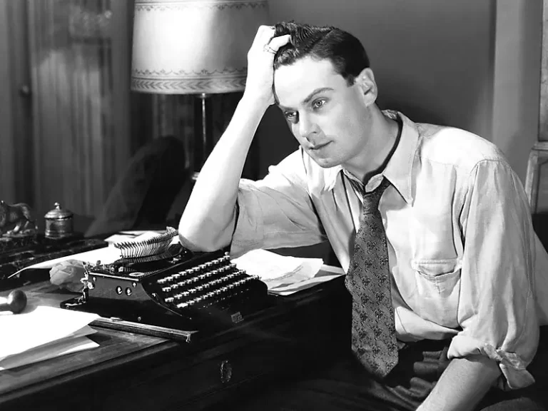 Frustrated writer at typewriter.
