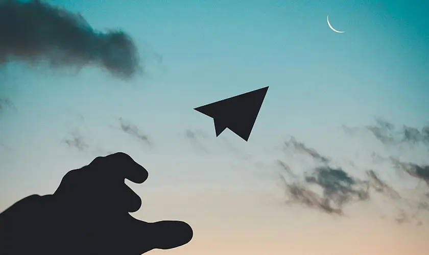 Paper airplane flying to the Moon.